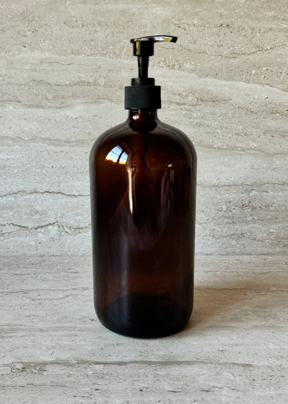Large amber glass bottle 32oz refillable sustainable design lifestyle shot