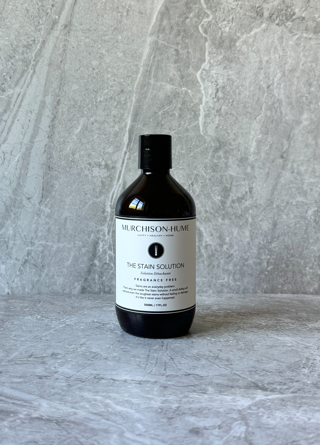 The Stain Solution on stone surface showing eco-friendly enzyme-based formula for tough stain removal